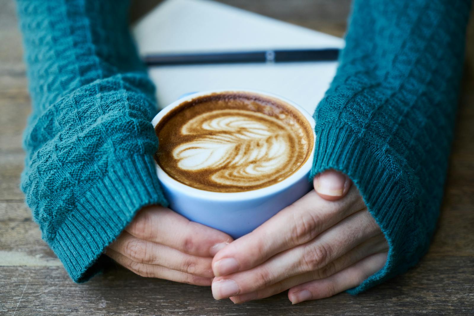 hands holding warm coffee