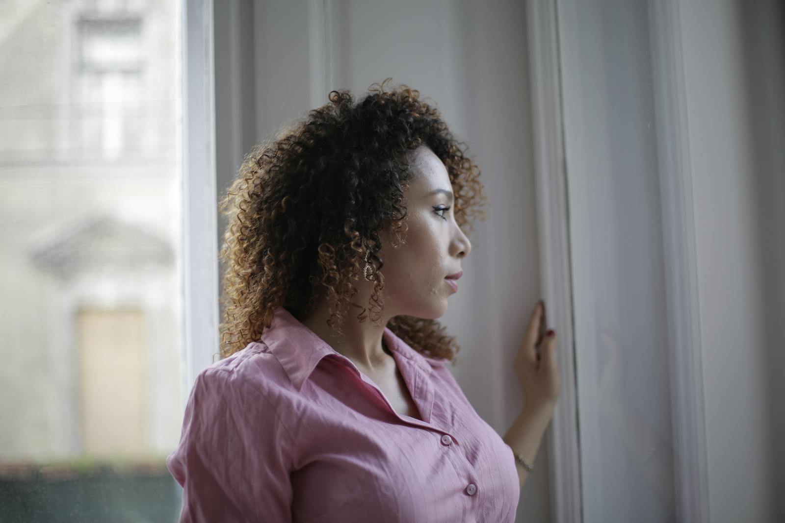 person alone window thinking