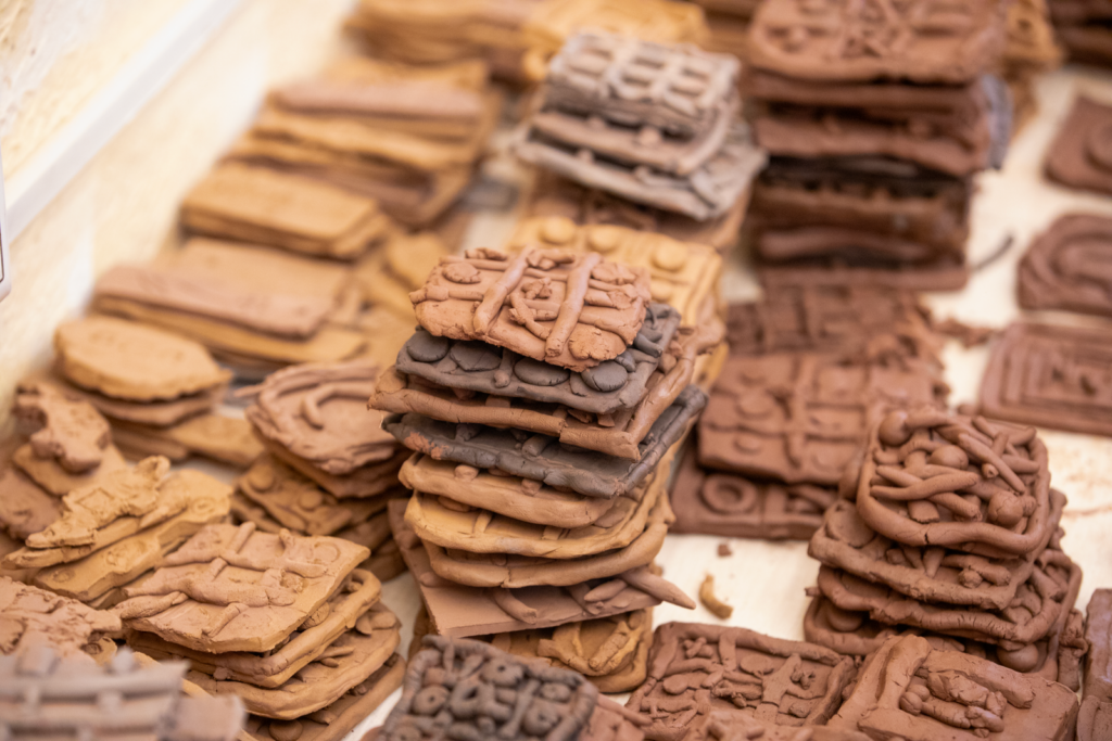 Ancient clay tablets inscribed with cuneiform-style script.