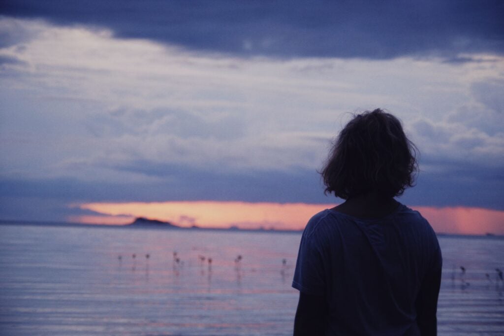 Representative image of a person looking at ocean water
