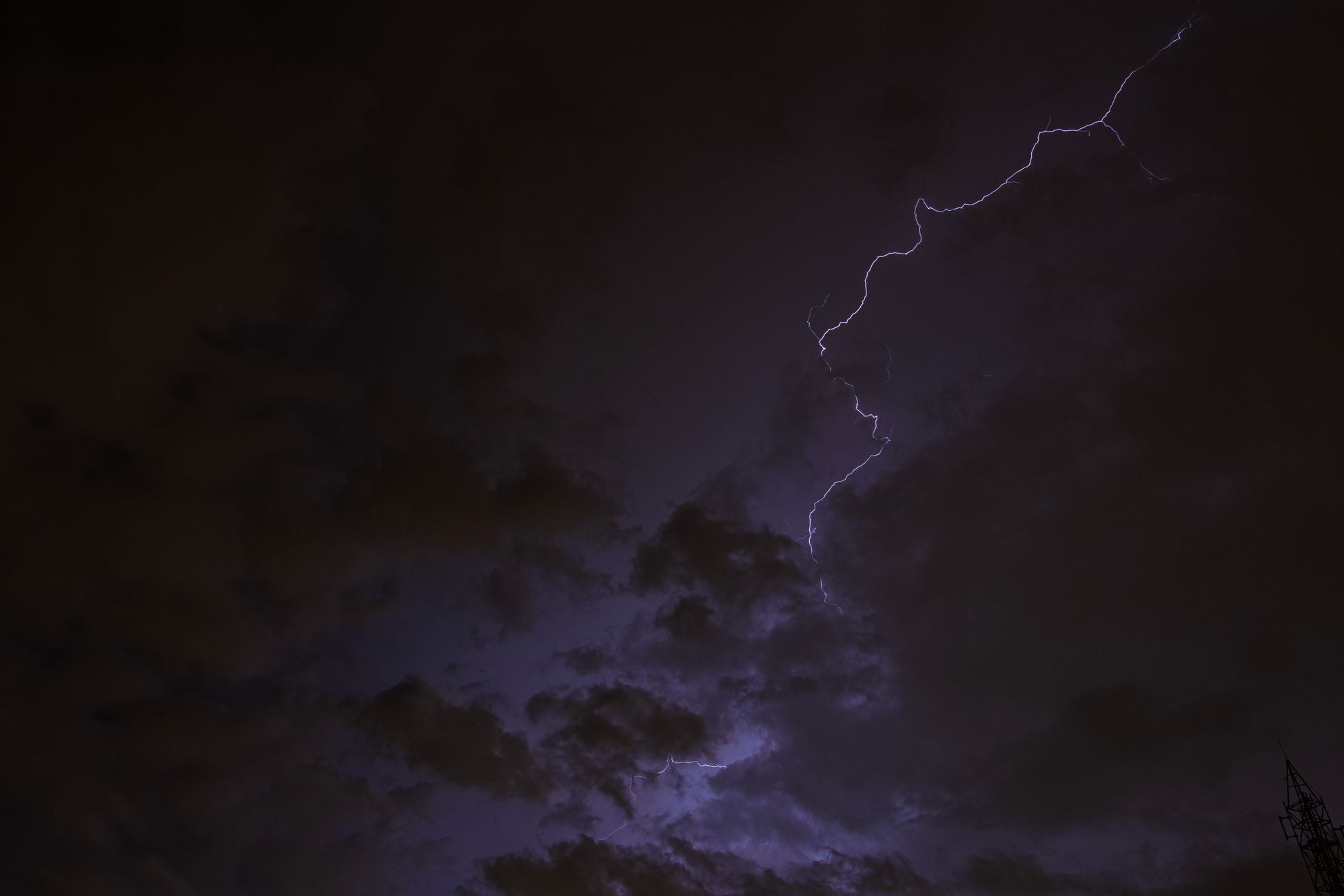 Dramatic night sky with vivid lightning streaks and dark clouds highlighting a natural storm.
