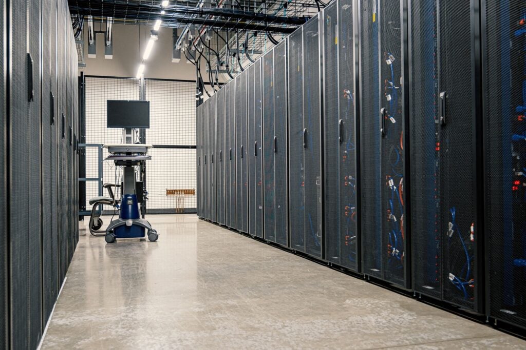 Rows of server racks inside a modern data centre